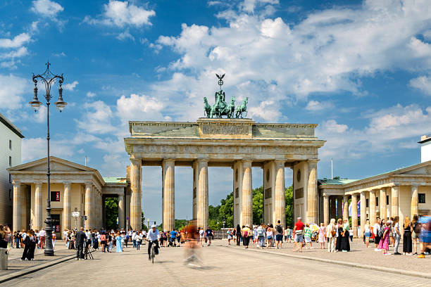 Brandenburg Gate in Berlin with Tourists and Blue Sky